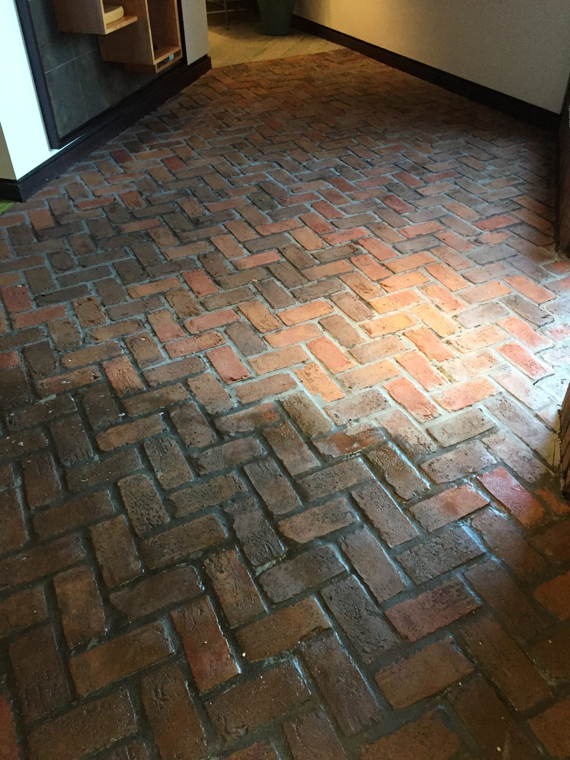 Pressure washing in Bartow, FL - Restored red brick paver flooring showcasing a clean, polished finish.