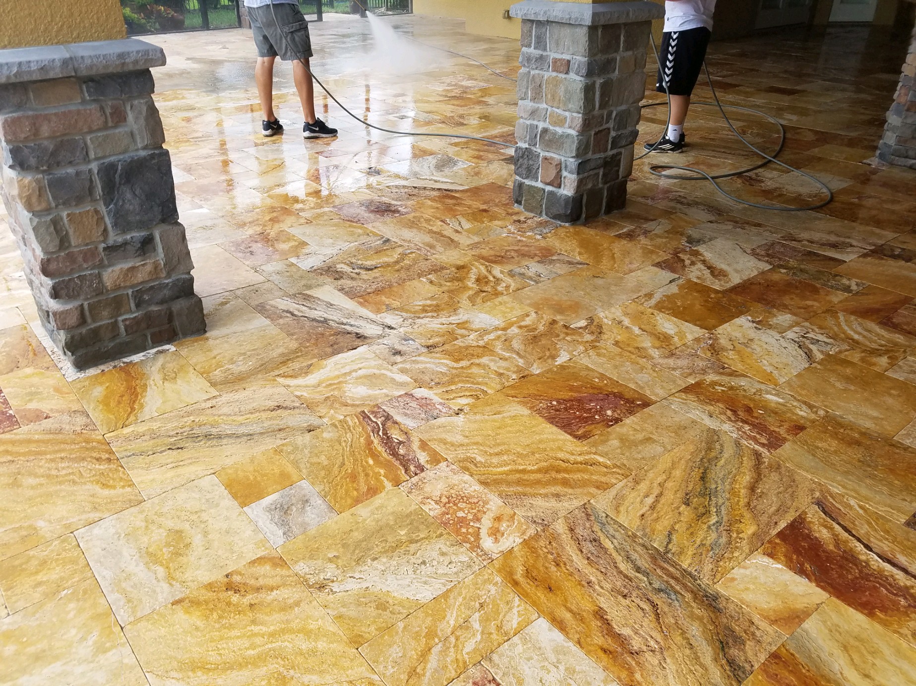 Travertine paver sealing in Auburndale, FL by PCE Pressure Washing, showcasing a glossy and restored finish.